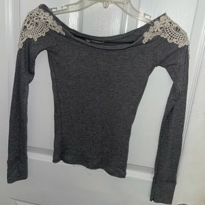 Grey top with white design on both shoulders